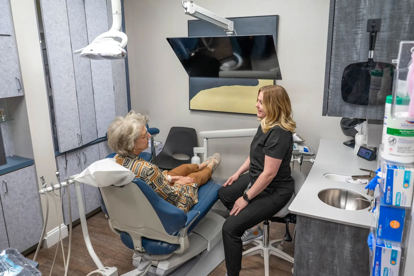 A hygienist treating a patient in a Highpoint Dental operatory