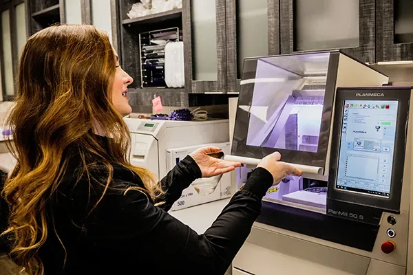 A Highpoint Dental technician operating the in-office CAD/CAM milling unit
