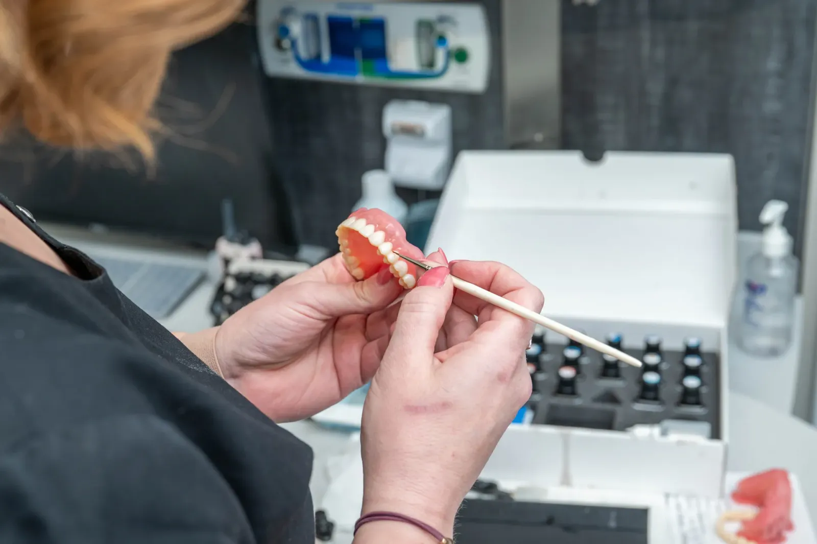 A technician hand-finishing a restoration in the Highpoint Dental in-house lab